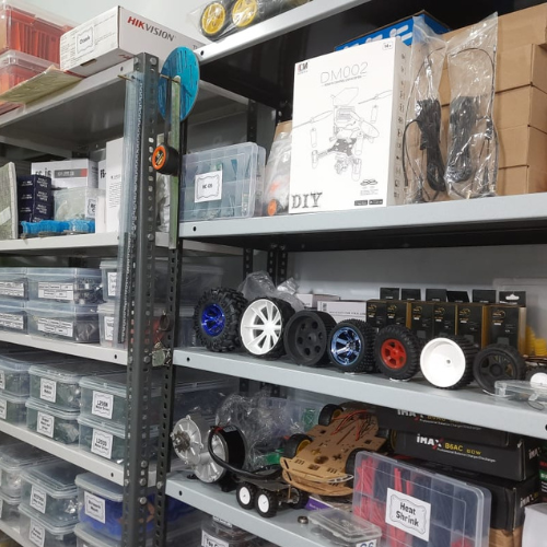 Shelf displaying various types of robotics wheels in different sizes and designs.